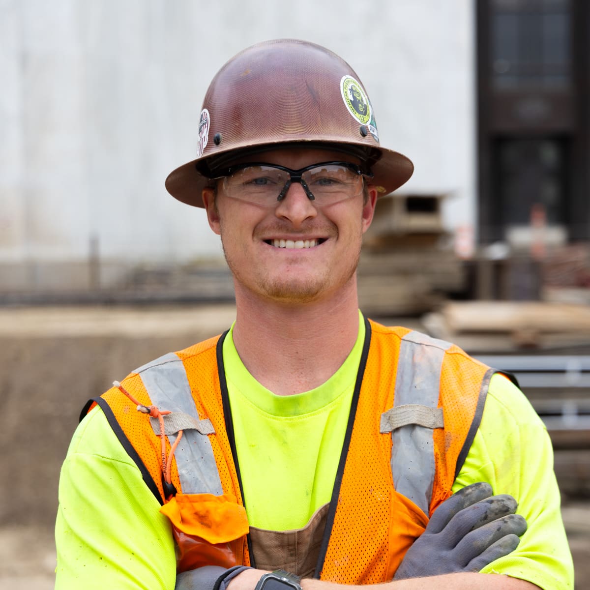 Foreman Wrangle Crane a construction worker in a hardhat and orange vest smiles in front of the Oregon State Capitol