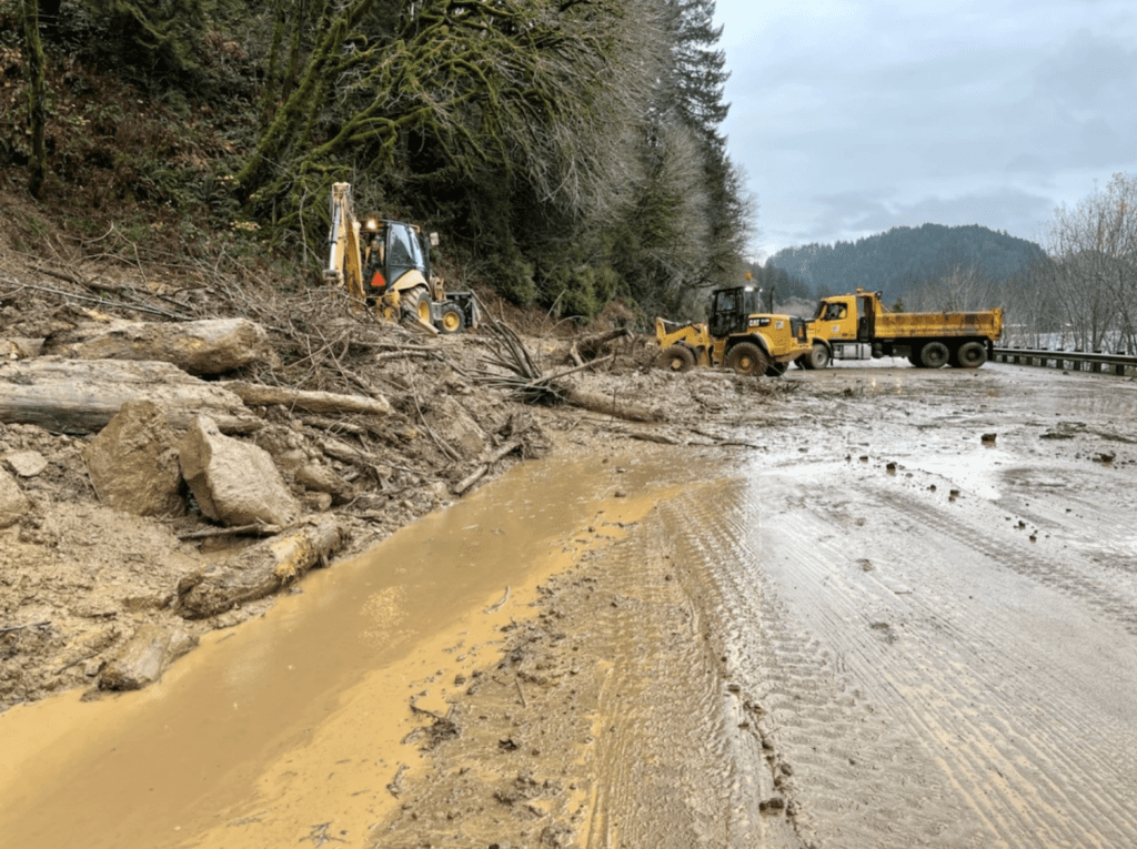Construction vehicles work on a slide Repair on Oregon highway OR-126