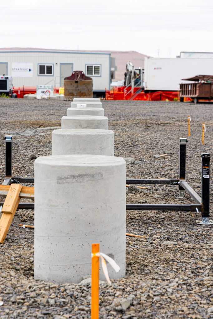 Close view of a shaft-top template and anchor bolts at Tower Solar.